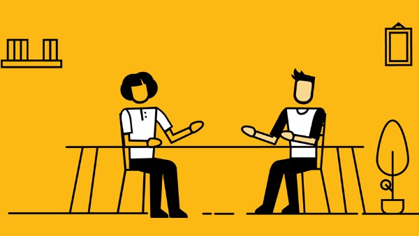 2 people sitting by a table
