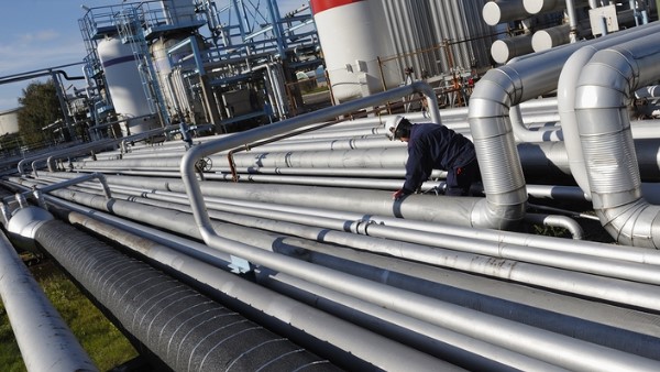 A man working on large industrial pipes